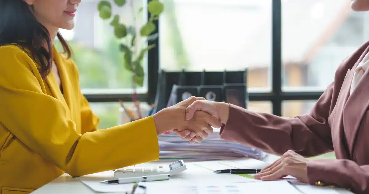 Insurance broker and customer shaking hands