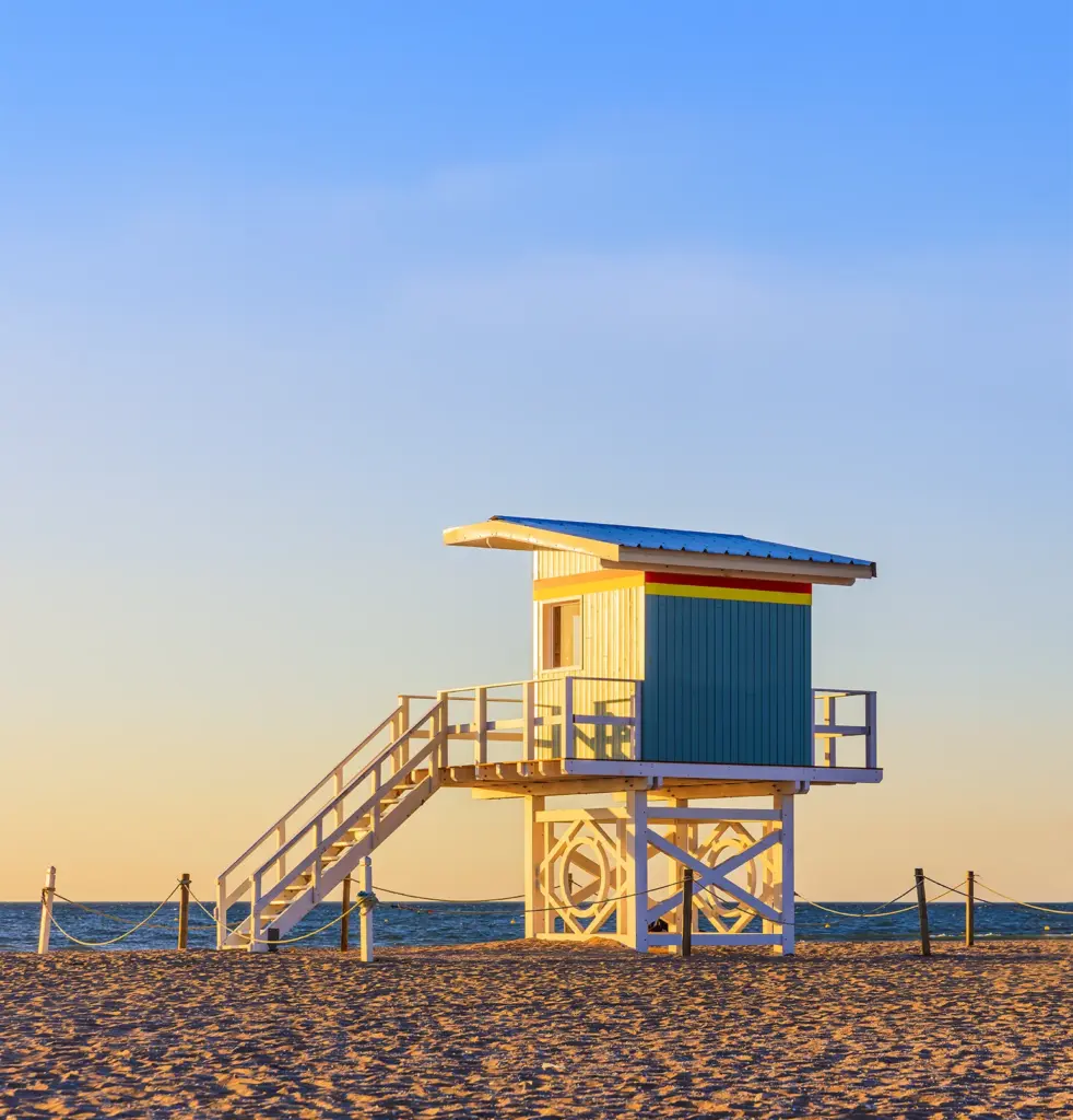 A lifeguard hut on the beach at golden hour