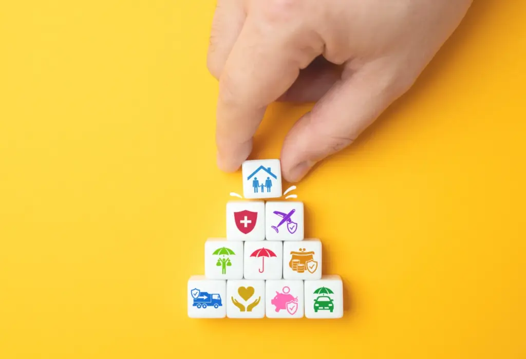 Stack of colourful pictogram tiles representing the range of insurance services Cofton Insurance offers businesses