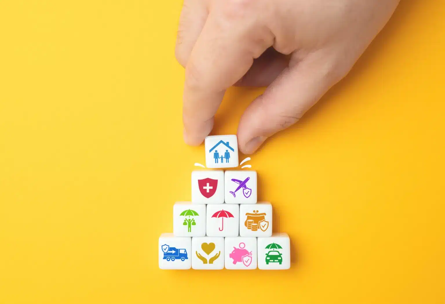 Stack of colourful pictogram tiles representing the range of insurance services Cofton Insurance offers businesses