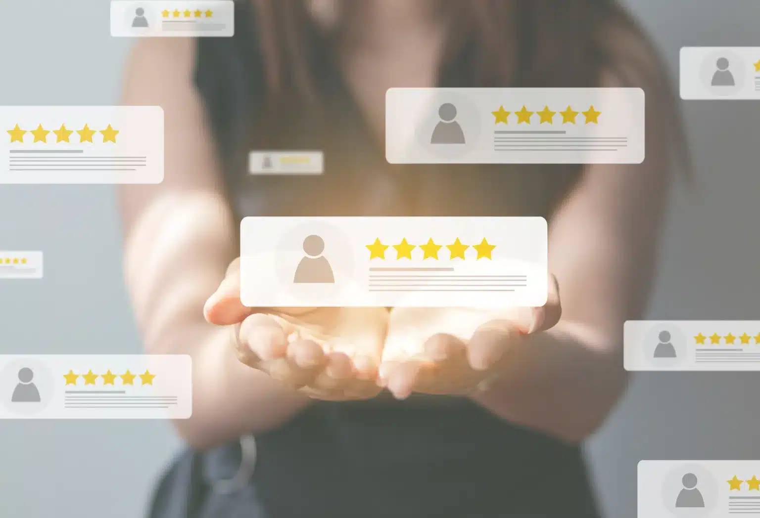 Hands holding floating virtual five-star reviews, representing good reviews.